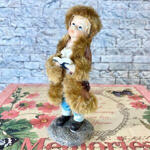 Greenbrier International Inc Polystone Girl in Winter Coat with Song Book